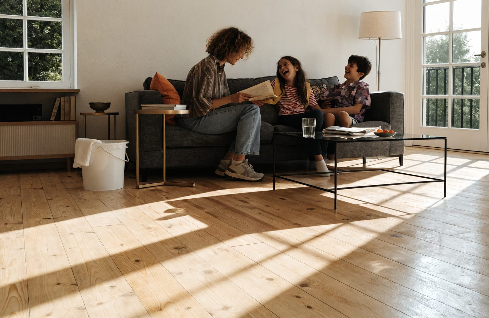 A family relaxing in a bright, freshly cleaned living room